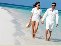 A couple walking along the beach.